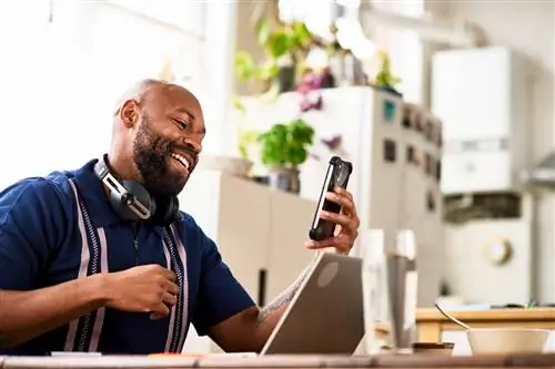 Мужчина средних лет реагирует на текстовое сообщение