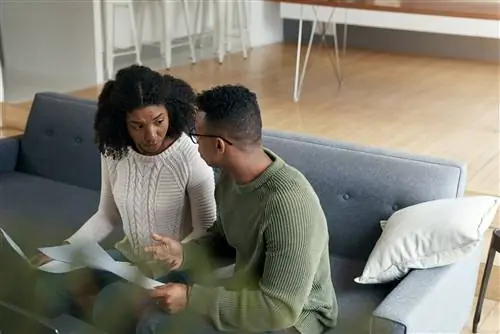 Молодая черная пара серьезно обсуждает на диване